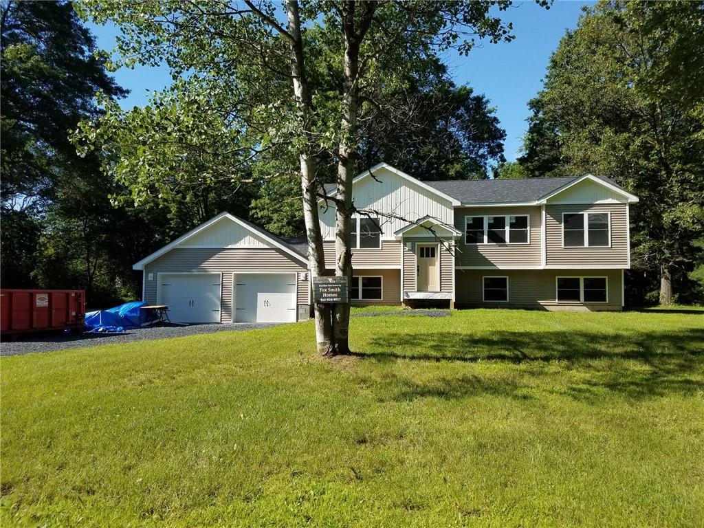 Two-story split-level home exterior — full renovation underway