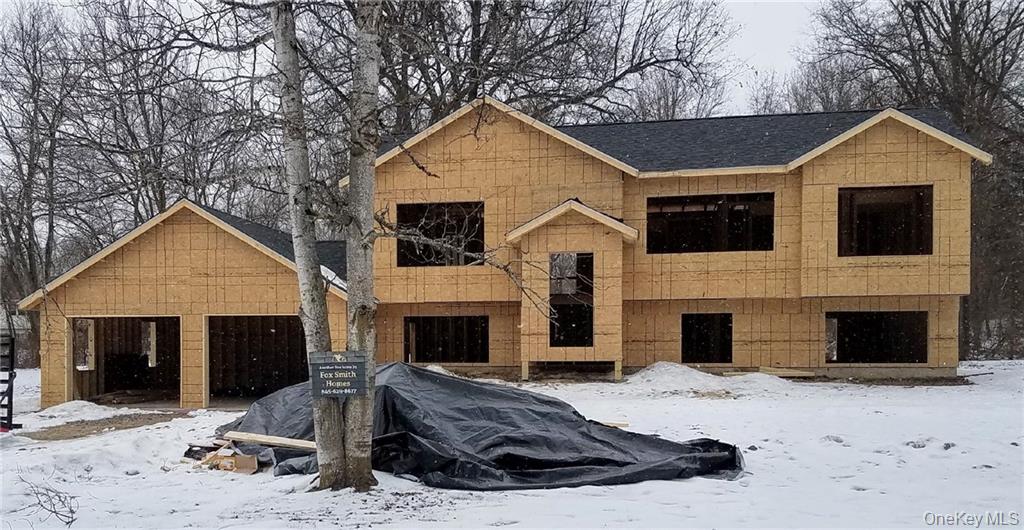 New two-story home — framing and sheathing stage with attached garage
