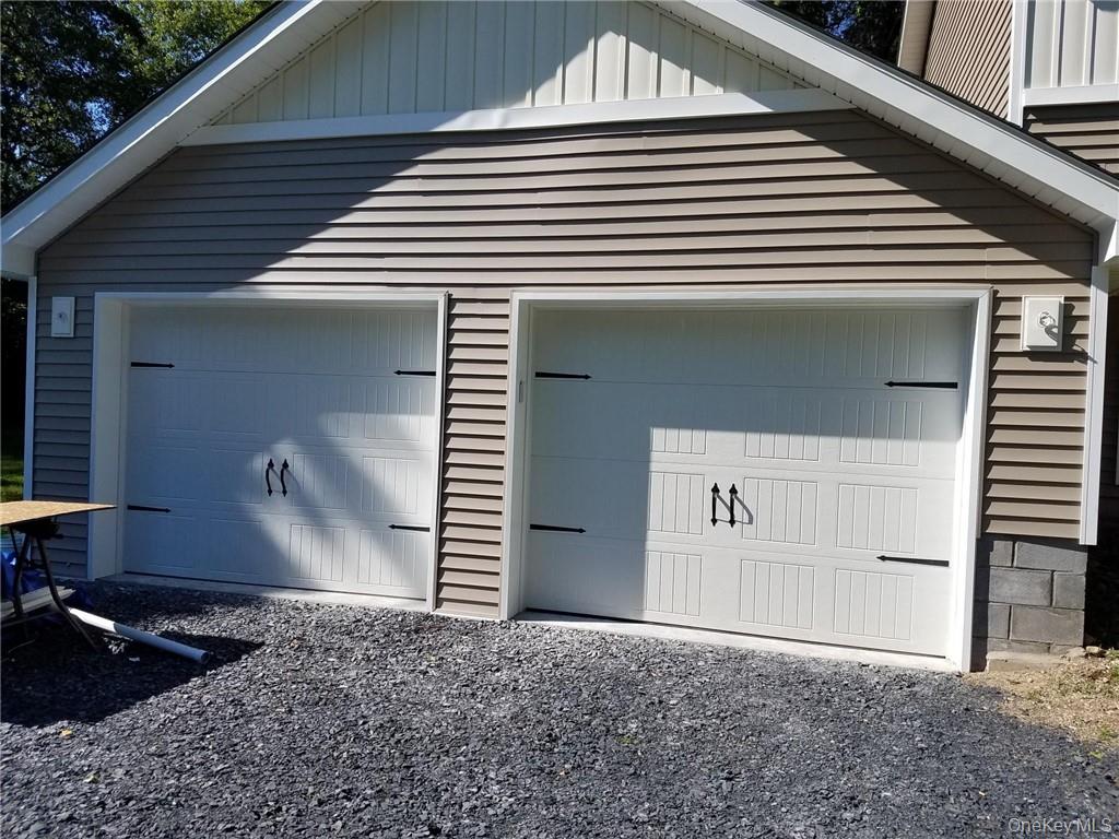 Completed detached two-car garage with new carriage-style doors