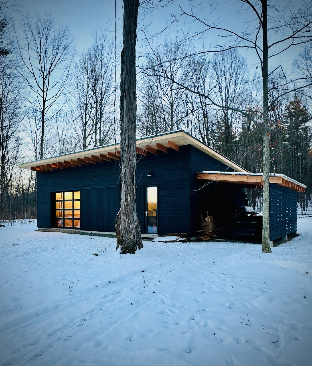 Completed studio exterior at dusk with warm interior glow