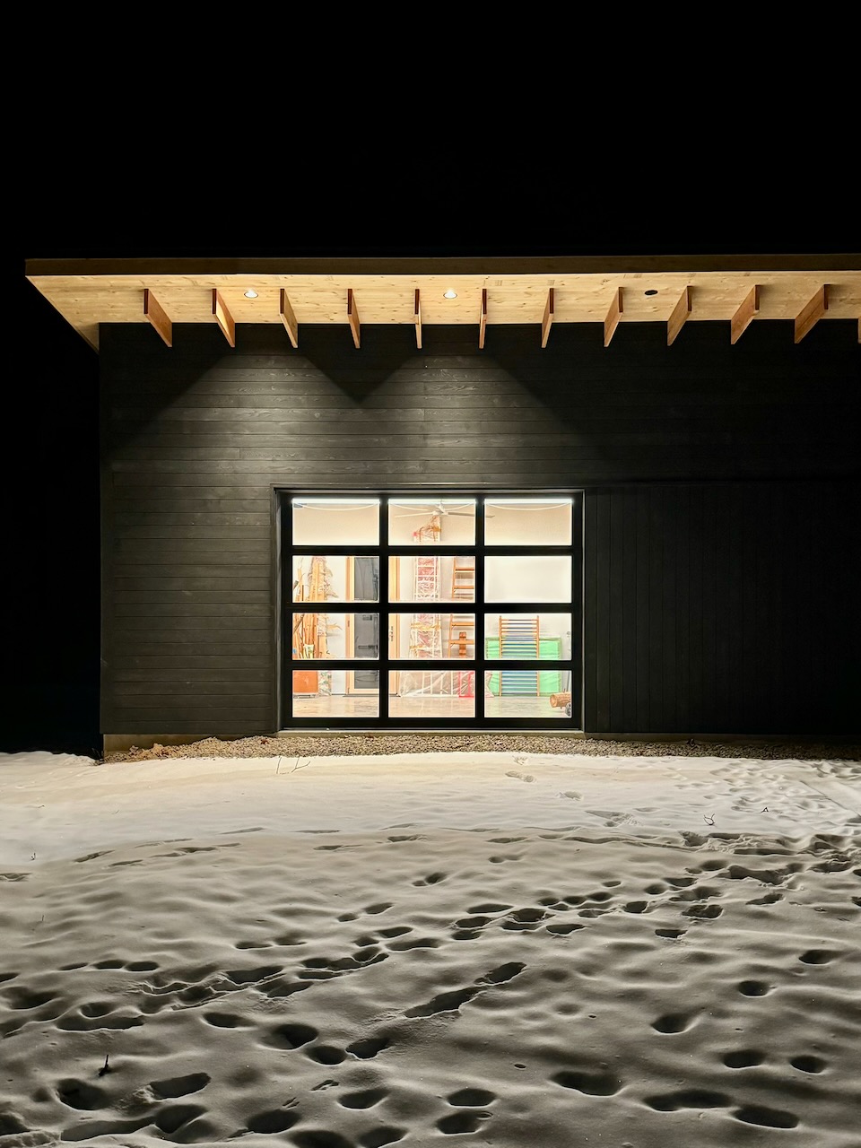 Custom studio — glass garage door lit at night