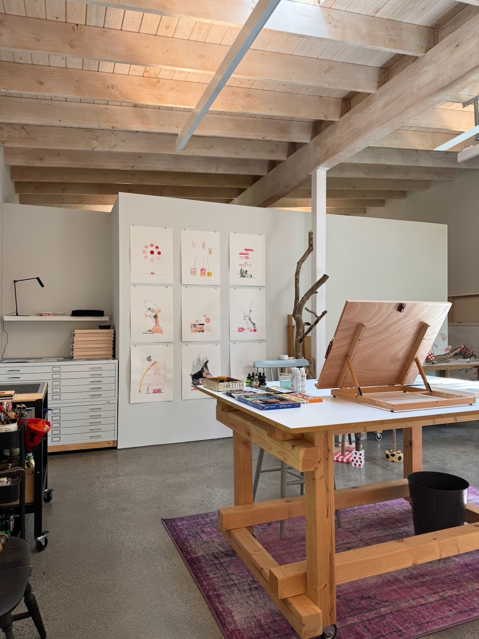 Studio interior — exposed post-and-beam workspace with art flat files